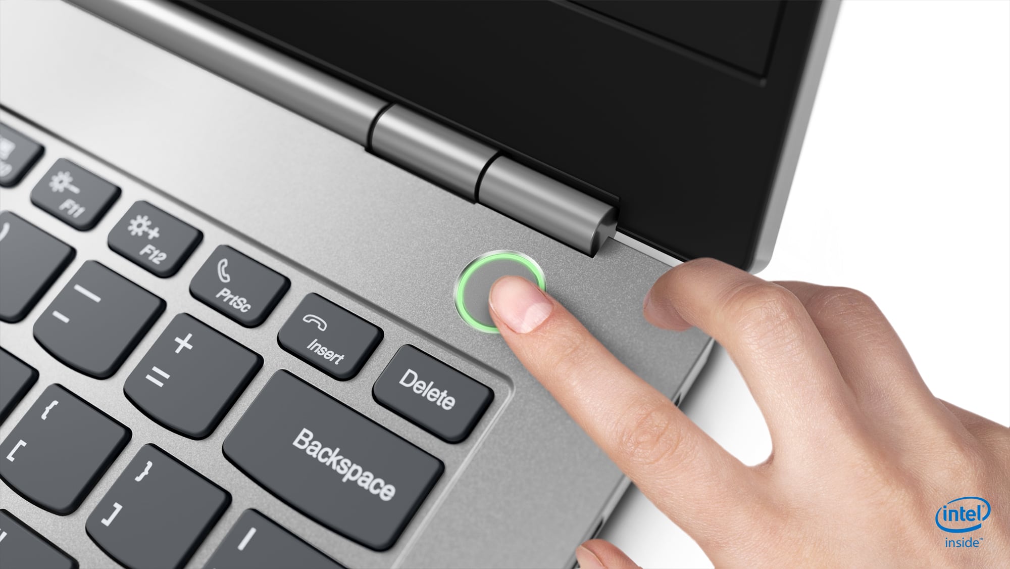 Finger on glowing fingerprint sensor on laptop